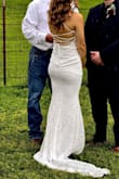 It was a very fitting and stretchy dress which personally I loved. It ending up raining on our wedding and was pretty muddy. Luckily, for it being such an affordable dress, I really didn't mind. I was just happy to be there!! 10/10 - Sierra F.