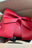 Upon opening, I loved the color, size, and size of this bag but was disappointed in the quality of how it arrived. It has these marks on the purse like it was painted over with a similar color red to cover scratches or something. I don't have time to deal with the return process so I decided to keep as is. - Nicole P.
