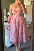 I don't know if it's me or the dress, but it does not look like it does on the model. It seems the waist is too high and is at my ribs, not my waist, and the skirt is much more poofy than it looks online. It is also a bit large. The back is a synch tie so that is able to be tightened, but the waist, where the zipper is, is too big and gappy. - Ashleigh W.