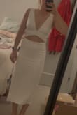 I really love this dress! The material is super soft and it is double lined which is always nice when wearing white. It is really comfortable and flattering! - Pietra S.