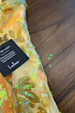 The color of the dress is beautiful, but the fabric quality is poor. It's made of low-grade polyester. The thread used for the applique details is coming loose, and as you walk, it leaves a trail of yellow sequins on the floor. Unfortunately, it will be a dress for one-time use only. - Raquel T.