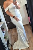 The cut of this dress is very flattering for curvy women. The cut is body-hugging, but it's a beautiful wedding dress. - Alejandra M.