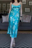 The color is exactly the same in person, and the fit is perfect! I have a hard time finding dresses that aren't too low cut but also cute at the same time! I have a small chest, though, so this may be a bit more revealing if you have a bigger chest. I got a large based on the size chart, and it was perfect. I'm typically a size 8. - Jesse G.