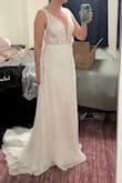 While I did love this dress, I ended up going with something else. It fit perfectly and I'm a medium in everything else lulus, so it seems true to size. I would've needed it hemmed about 3-4 inches. I'm wearing some 2.5 inch heels in the photos, and I'm 5'7. It's got a nice, simple, short train and a flattering draping skirt. The waist has no give, so be careful of that. I also found that the straps on the back would bow out if I pulled my shoulders back. Not sure if some alterations would fix that or if it was because of the low cut. Overall, gorgeous dress and I loved the way it looked, but I went with something else for my wedding dress. - Tricia M.