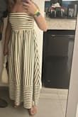 I wore this on vacation in the DR. It is so good on. I don't love the color of the khaki between the green on the hanger, but it looked good on. The straps are adjustable, and the back is stretchy material. - Emily M.