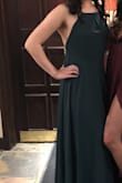 This dress is so cute and the colour is gorgeous! However, it says the fabric is not stretchy and it's not, however, the waist band is stretchy in the back. I would recommend looking at the size chart and if you're smack dot on the size lower end of a size, go smaller! Other than the size, the neckline is a little wide so my tailor bunched it up at the top and it looked super cute and the dress needed to be hemmed for length. - Denise M.