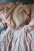 The dress fit perfectly before I washed it. After putting it through a delicate cycle and a heatless tumble, the dress unfortunately had a large tear down the front of the dress. - Emily E.