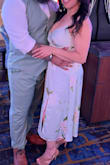 I wore this for my son's Vegas wedding. Extremely happy with my choice. The fit is absolutely perfect, hugging in all the right places. I purchased a medium for comfort, the picture with it long is a small. I attached the photo of it long and shorter. I had it altered to a shorter fit. The fabric  felt luxurious, and I received so many compliments. I highly recommend this dress. - Deserie C.