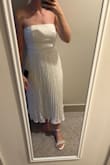 I ordered this dress for my rehearsal dinner as the bride. I am typically a small in everything at Lulus, but this dress is extremely tight and unforgiving in the bust and rib cage area. I kept the small because it ultimately fit me, but is super tight. I decided to just deal with it since I don't have time to reorder. Consider sizing up! - Emma L.