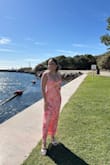 It fits well, especially if you are not looking for something to hug you like a glove. The material is soft and feels good on the skin. I wore this to a beach wedding. I thought it would be too long, but it's not touching the floor, and I wore a 2-inch heel. - Lorissa B.