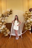 I got this dress to wear to my bridal shower, and it was perfect! The bow was unique and got so many compliments. It was a little big in the chest area, but I wouldn't have sized down simply because it fit well in my hips. I had it altered, and it was beautiful! - Brooke B.