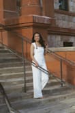 I absolutely loved this jumpsuit! I wore it for graduation and it fit my body like a glove. I am about 5' 9" in heels, and this jumpsuit still fit very well, thus, I'd recommend wearing heels for the shorter gals. Otherwise, the material and quality are amazing, and the neckline is super cute! - Naomi L.