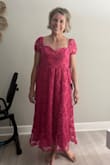 Pretty but too many negatives to wear. As you can see the scalloped neckline is a regular. My biceps are 11 1/2 inches around and it was tight. The sleeves are itchy. Unfortunately, I don't remember if this one could be zipped or not. - Jody L.