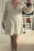 This dress is beautiful in person and very flattering. The colour is a bit more cream than white. I bought this for a bachelorette trip and think it will be great. - Kathleen Y.