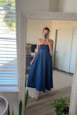 Material is comfy! Elastic around the lower waist and bust. The bust feels really secure and thick (plus adjustable straps). Needs light steaming for creases, but is SO cute! Can't wait to wear this weekend. - Tiff S.