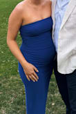 I was about 18 weeks in this pic- this was the perfect dress that showed the bump. It went just below the knee. The perfect blue!! I will say the color did transfer to my white nails throughout the night but I didn't notice it on chairs or anything - Jenna B.