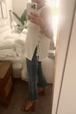 This tank top has become my new go-to. It's flowy, comfortable, and the sides give it a stunning detail. Great to dress up with nicer pants and heels, or keep casual with a pair of jeans and some sandals! I really wish this came in more colors or that there were other similar styles out there.
I ordered larger than I'd typically wear in tops (I'm usually a medium or large depending on the style), so that it was a little longer; since it's not meant to be tight, you cannot tell. The sides do not really open up more than pictured, no matter how you adjust the ties, so it's not overly revealing. I just wear boob covers with it :) - Meagan L.