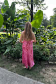 I'm 5'0 and was looking for a dress that would feel elegant without overwhelming my petite frame;  this one is a winner! The fit is beautiful and the adjustable tie-back makes it easy to get just the right shape. The vibrant pink with red floral print is even more stunning in person and photographs so well (as you can see!). The side slit adds a fun touch without being too revealing. I wore this to a summer wedding and got so many compliments! It's lightweight and comfortable for outdoor events, too. Highly recommend for petites or anyone wanting something bright and feminine! - Kelly S.