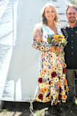 I love this dress. I wore it for my wedding. So unique and colorful. Lots of compliments! Great price point. I ordered both a L and XL and decided to stick with the XL to allow more movement/cleavage control in the bust (I could have worn the L without a bra/stickies). Fabric not stretchy but not uncomfortable either. So fun <3 - Hannah F.