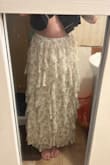 Has a stretchy waistband and stops right at my ankles. The design isn't solid throughout - when you lift a ruffle, it's just plain white fabric underneath, which I think is odd but not noticeable. Soft and not see through! - Nicole S.