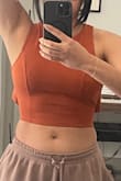 This fits perfectly around chest and shoulder, it's nicely fitted. The issue? Well I need to return because just like a few other buyers it flares out on the sides; there is no way to get the material to lay flat on the back no matter how much you tighten or pull down. I wish this wasn't a problem or I will definitely keep it but I'll be returning - Katherine D.