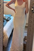 This dress is beautiful! For the price, it is great quality and I absolutely love it. The fabric is thicker than what I thought it would be which is a bonus. I am 5'8 and it's a great length for me. You can just barely see my toes barefoot, but there is still a small train with some length to the back. I'm wearing this as my second wedding dress so I can move on the dance floor a little easier and it is perfect! It's a darker ivory color bordering on champagne but I think that adds to the elegance of it. - Sydney H.