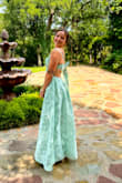 This dress was amazing, I got so many compliments. I love the bow in the back because you can tie it to fit your body. Totally recommend this. I ordered it in Large and it was too big, the medium fit me perfectly. The material was great too. - Kathleen R.