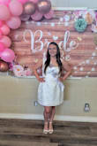 It's a beautiful dress and well-made! It looks and feels pretty luxurious. I wore it to my bridal shower and got so many compliments! 
Though I will say the proportions aren't ideal for shorter people. I ordered a size large for bust and waist measurements (still felt more snug than I would have liked)- but this made the straps extremely large. However, I was able to secure them from sliding off my shoulders with double-sided clothing tape! The material is opaque and thick enough that a bra/cup wasn't necessary- although I still used a boomba for comfort. 

For reference, I am 5"1 and 145 lbs 

Overall, I highly recommend! (I sadly didn't get any photos of the back) - Sara K.