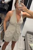 I ordered this top and matching shorts, very cute set. I could've probably sized down to an XS since the back is just tied (& the shorts are elastic). The front also does this slight flare out, but only on the right side. Overall comfy, fabric isn't super soft, it's meant to hold its shape. Will be keeping & hoping it shrinks a bit in the wash. Athletic build, 130lbs, 34C/32D, waist 28", ordered a small. - Brooke J.