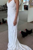 I'm not one to just spend money for the occasion. So, I didn't want to spend much on my wedding dress. I used a coupon and got this beautiful dress for $278. It's so sparkly, white, and does not look like it cost what it did. It fits really good. I ordered a size S, and I did have minor alterations because I'm not that busty in the chest. - Desirae M.