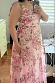 I really liked this dress, but ultimately decided it wasn't my style. The floral pattern is really pretty - not too big or too busy. The slit is the perfect height. The dress was a little long on me but would have been fine with heels. My only complaint is the straps - they were about an inch too long (the bow is deceiving and is sewn on - the straps are not adjustable). I liked where the skirt hit me and smoothed over any areas I feel insecure about. The material is lightweight and would be perfect for a spring or summer wedding! - Lindsay C.
