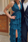 This dress is absolutely stunning! The pleats and material are so elegant, and the open back is not only beautiful but also super practical; you can adjust it to fit just right. It felt a little big at first, but the tie-back made it easy to get the perfect fit. The built-in slip made it super comfortable and easy to move in all night. I got nonstop compliments and felt amazing wearing it! - Kyley L.