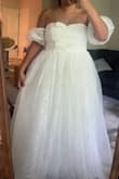I was blown away by this dress! The quality of the dress was great, especially for the price. It felt soft on my skin and felt lightweight. The bows are such a cute touch, and the shape is perfect, free, and flowy, perfect for dancing. I was worried that it would be hot as I had a summer wedding, but it was seriously very light and I danced for hours in it. I had just a little difficulty with the zipper on the dress when putting it on as the top is not very stretch- however, once I got passed that, it was a comfortable fit and not tight at all. - Jasmine W.