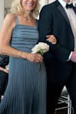 I was searching for a Mother-of-the-Groom dress. Loved this slate blue dress the first time I saw it!  I am usually a size S, so I ordered the dress in a S late summer of 2024 for June 2025 wedding.  Then proceeded to spend way too much time, looking at other dresses, just incase this was not The One!!   Dress was always snug when zipped.   Took to have altered in April 2025.  When picked up, the dress now easily zipped, but did not look good!  When the dress was made slightly bigger, they flattened the pleats below the bodice, on each side of the front.  Right away, I checked to see if M was available, not in stock until after the wedding.  Checked a week later and there were 3 mediums in stock.   Ordered and had shipped express.   Had the straps altered, dress shortened and removed the bow.  LOVED the dress and the way it flowed.  Received so many compliments!  Happy Endings are The Best!!! Photo on left is the true color. - Nancy B.