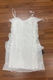 A small dress designed for a slim figure or a young girl. It is short in length, usually above the knee, and features a simple yet elegant design. Made of lightweight fabric, it offers comfort and style for casual or semi-formal occasions. The dress may include delicate details such as lace, ruffles, or a fitted waist. - Bibiana A.