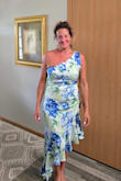 I ordered a large and fits just right. I'm average size and build. The sleeveless side of the dress does come down quite far into the arm pit but I've got some body tape I will use so that it does not slip down more.  Quality is good for the price. Wearing dress to my son's wedding, didn't want to look to look old and stuffy! Hope this helps anyone because the model in picture does not show a true front photo. - Sheila D.
