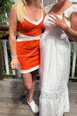 I went with the medium and was concerned it was going to be too short. I didn't have to bend and snap, so it was fine for event. Not much stretch at the cut out but there is some at the bust. Can dress it up or down; I went down with the vans but could have equally dressed it up with heels. - Krystle H.