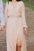 I was looking for an engagement picture dress, when I saw this one I just had to buy it. I knew I had to measure myself and get the closest size, which was a small. However, I figured because of the length I had better ordered an XS. The fit overall was good, BUT when you look at the model in the dress. In person the dress was MUCH open around the chest. So when you have someone that's petite and not busty this dress causes issues. I had to pin the dress at the chest even with my best bra. I had to buy a sparkly belt for it because it created a fabric "bubble" around both sides of my waist. The belt covered it up the best it could. When I tried it on a second time the button on the sleeve popped off. I just think for the price tag and the quality, I wasn't too happy. BUT I will say the dress photographs really well! - Leslie S.