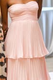I was nervous about buying this dress because I was afraid that size XS would be too small and size S would be too big. I have always been between the 2 sizes. The dress fit perfectly, and shipping was fast. I got 2 dresses but decided to keep this one, and returning was easy. I wore it to my dad's birthday bash, and I got a lot of compliments. It was a bit too long, but I had it tailored by a professional who also really liked the dress. I travelled 26 hours with this dress in my luggage, so it was a little bit wrinkled, but not as much as I expected. I used a handheld clothes steamer to remove the wrinkles. WARNING: If you decide to use a handheld clothes steamer, use the lowest setting and/or hold the steamer about a foot from the dress to avoid flattening the pleats. For fellow small-chested girlies, no bra or nipple covers needed for this one ;) - Maleeta D.