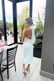 This was my first ever lulus purchase and wow was it a good one! I bought this for an engagement party in Rhode Island and got SO many compliments on it. The bow and low back are so dramatic and sexy without being over the top. The length was really nice (though I would caution taller girlies as I am 5'3 and thought the slit sat just right) and the fabric was fairly stretchy so I didn't have to worry about being uncomfortable throughout the day. I saw some other reviewers complaining about it being see through -- I didn't experience this, though I did wear nude shapewear and pasties. I wore out out after the party to a few more bars and it was super comfy/easy to dance in. Got it on sale but would not hesitate for a moment to purchase it again full price. 10/10 for any bridal type event! - Samantha P.