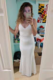 This dress is really nice but the material is very thick and heavy. It is nicely fitted and shaped. The color is a pristine white. Definitely thick enough for colder climates but the weight drags the dress down. - Alyssa S.