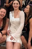 This dress has a lot of stretch and is super flattering! I am 5'2" and this dress was VERY short on me, but I wore it anyway because it was so cute and comfy! The pearls didn't bother me when I was sitting. I definitely highly recommend this dress, but be aware that it is quite short! - Gretchen F.