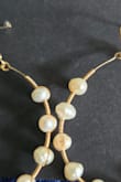 The pearls look like teeth connected together with wire, like medieval dentures. Also the one pearl on mine looks like it was melted and I can see every layer of the pearl. - MacKenzie K.
