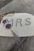 Love this wristlet.. HOWEVER, the bracelet that comes with it definitely does not fit over the wide part of my hand, so I swapped it out with another bangle I already had. The 2nd issue I noticed, and it wasn't until I recently took photos to show some friends, was that the "S" is off balanced from the M and the R. - Chivon P.