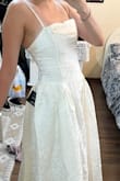 The dress arrived faster than expected. It's perfect, exactly like the picture! I bought it for a pre-wedding photoshoot, it fits the vibe I'm going for. I'm so pleased with this dress and I can't wait to wear it. 
Also, the sizing is perfect. I love the back so much. - Nardeen H.