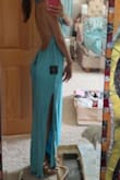This style was very flattering with the open back and the slit, but from the front, it was not. The material is a bit more cheap and plastic looking than I was expecting. It was also much too long. I tried it on with 6 inch heels, which would've made me 6' tall, and it still was dragging on the ground. - Cici S.