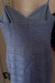 So I got a completely different dress than I ordered. It's not lavender at all, it's periwinkle. Also, there is a sheer outer layer with glitter on it, and I don't see that in the picture? It also has a zip up back and NOT a tie up back. Luckily for me, I actually like the dress that I received better than the one I ordered. But if you want this dress, well you're not gonna get it. - Ava P.