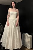 I will admit that I was nervous buying a wedding dress that I had never tried on, and there were only two review photos. However, because of the sale, I decided to give it a shot. When it arrived, I tried it on immediately. Obviously, it will need to be steamed because it was inside of a box, and despite the fact that it needs to be taken in a little bit in the body. (Thus why I'm holding it back) It's absolutely perfect and it has pockets. It is heavy, but the material feels nice. (Excuse my dirty fan behind me lol) - September B.