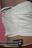 The back of the shirt fits so badly, and the material back there is different. On me, it forms this odd lump. The front of the shirt is fine and is really interesting. Unfortunately, they package pleated items horribly. So have fun carefully fixing and ironing out wrinkles from them. I was excited to have finally found a top for my Ralph Lauren skirt.  Only to be disappointed, I feel I've been returning more than keeping lately. Hopefully, sizing down will help - Crystal O.