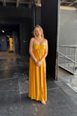I was 5.5 months pregnant when I purchased this gown for the end-of-season concert at my opera summer festival. I had grown out of all my gowns and was looking for a bandeau-topped gown to disguise my bump. I felt so pretty in this golden color, which really caught the light on stage. Really low-maintenance fabric too, as I bundled it in my bag and did not have to iron upon taking it out. Highly recommend, especially for wide-shouldered/defined collarbones ladies. - Mary B.